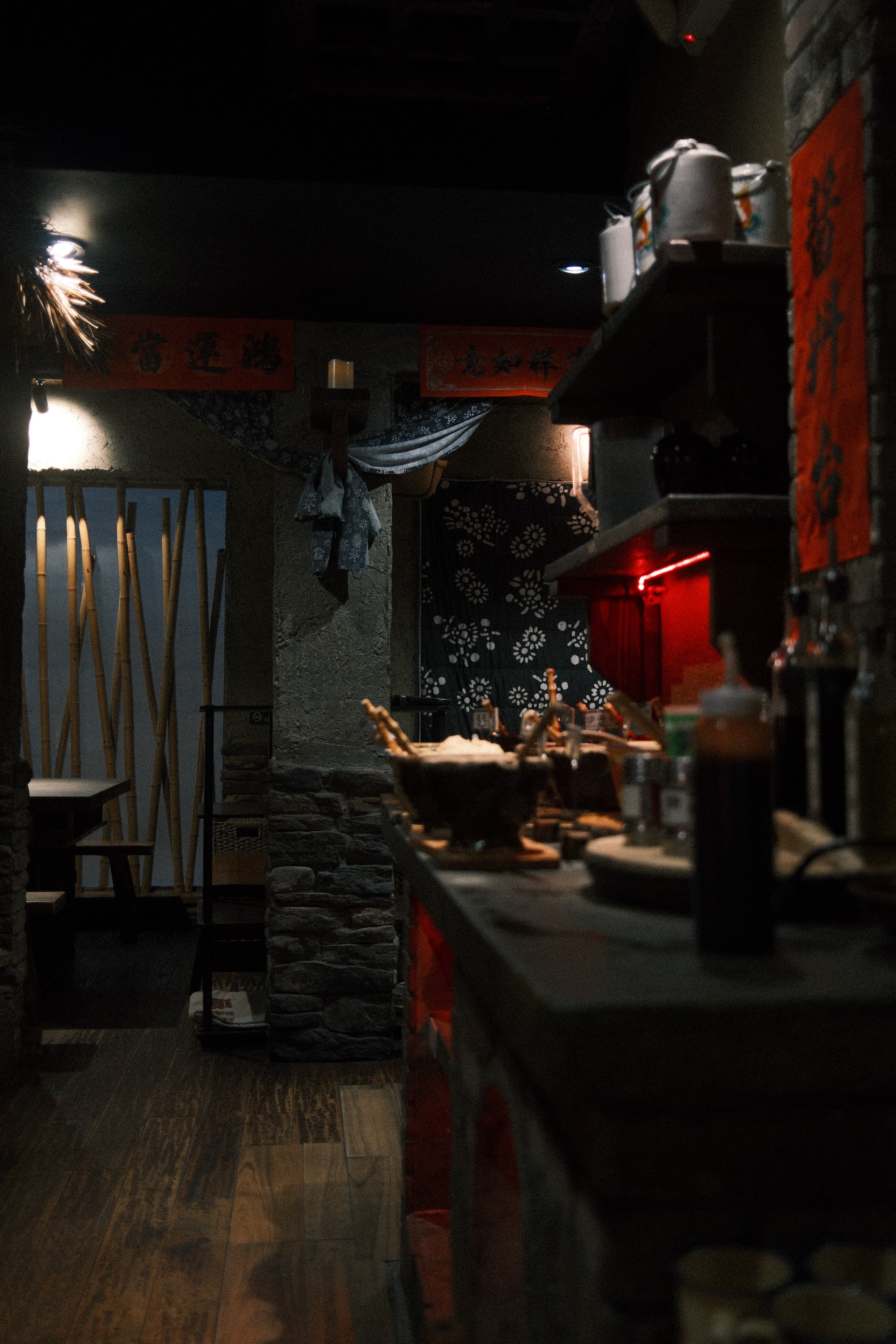Dimly lit restaurant interior with red accents