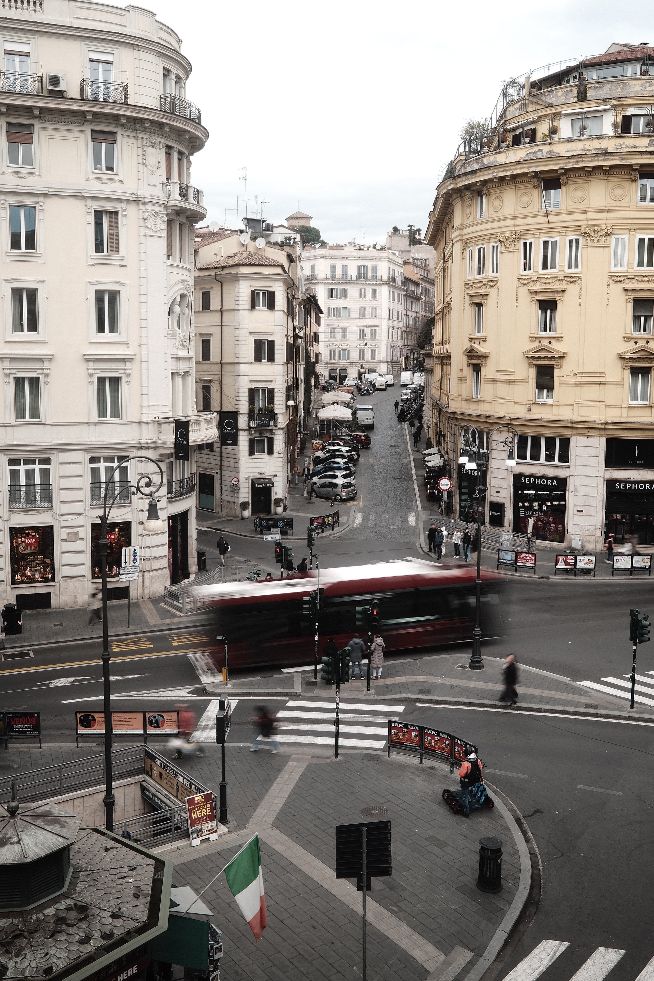Paris intersection framed by pale facades and a streaking bus