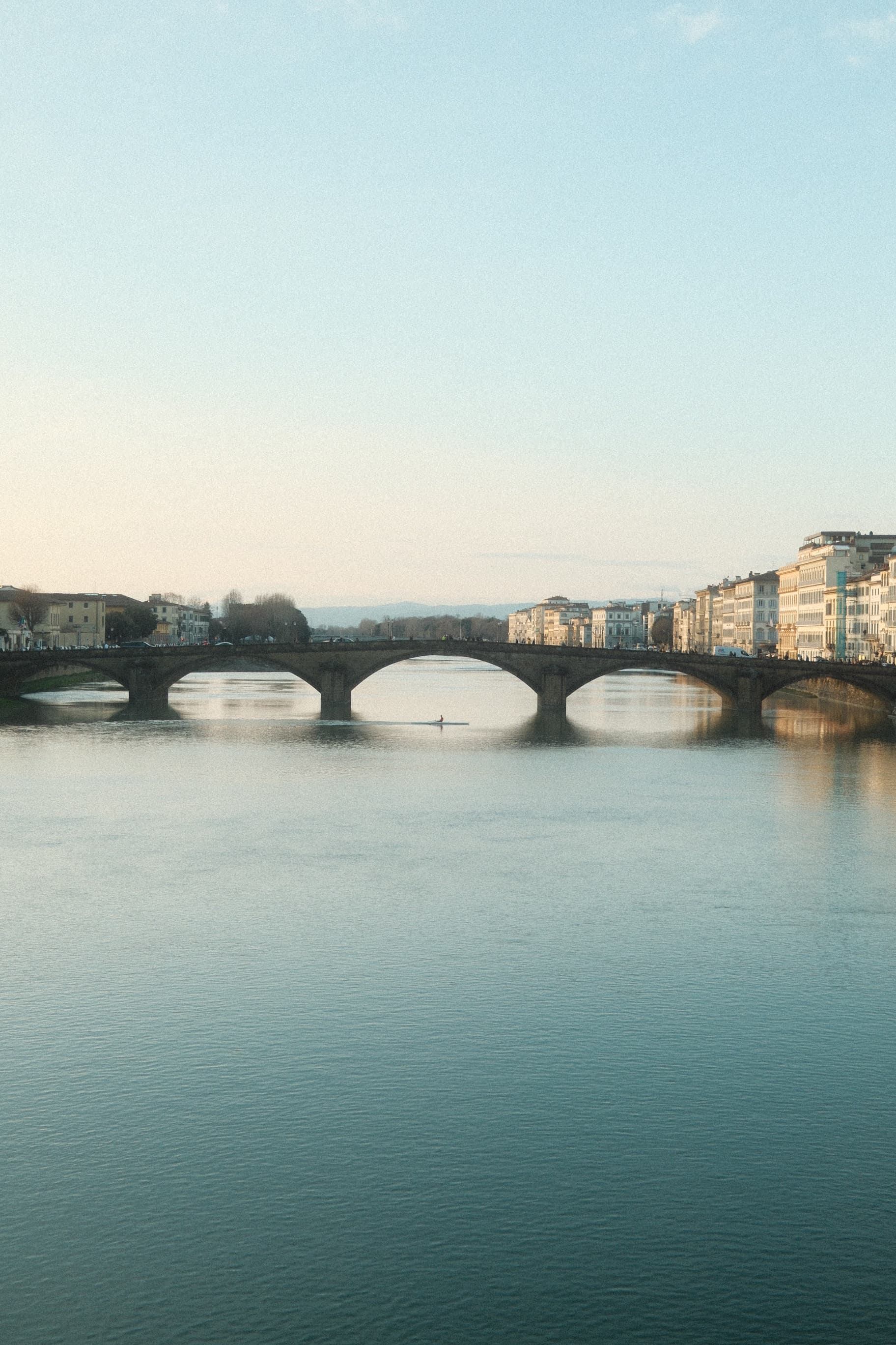 Bridge stretching across calm water at dusk